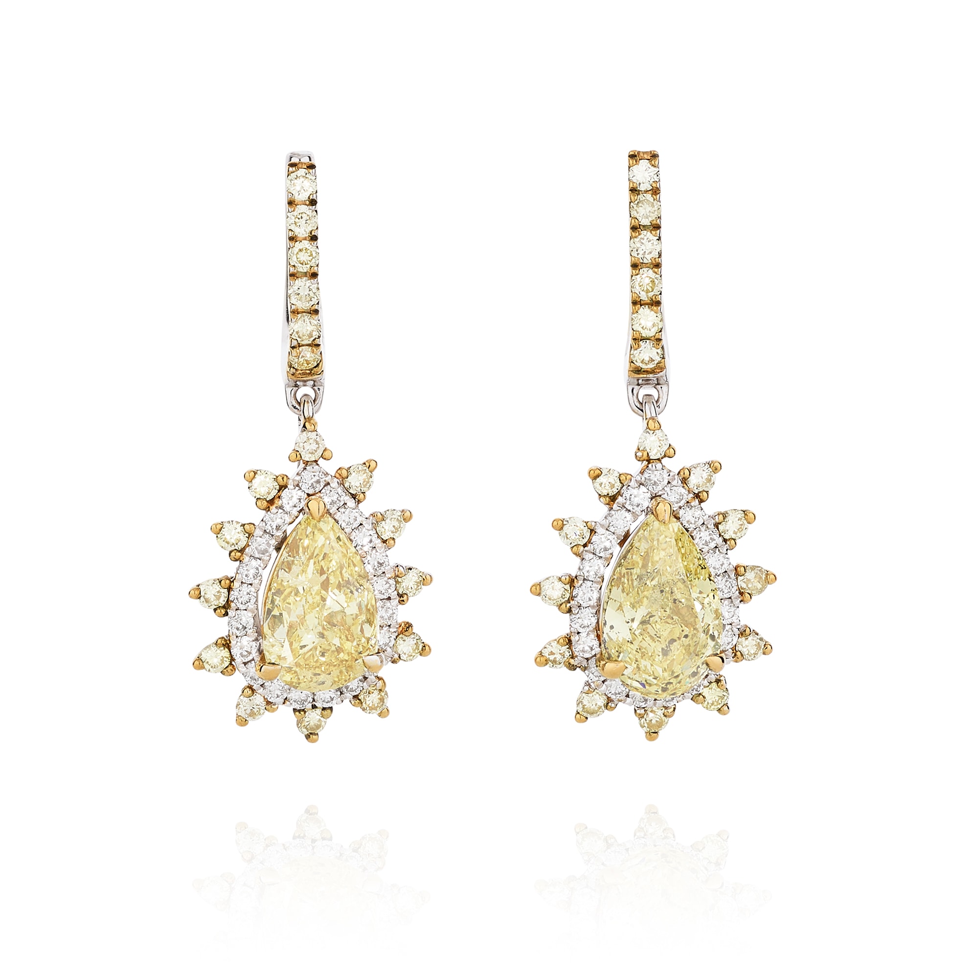 <p><em>Pair of fancy yellow diamond earrings, weighing 1.28 carats and 0.99 carats</em></p>
