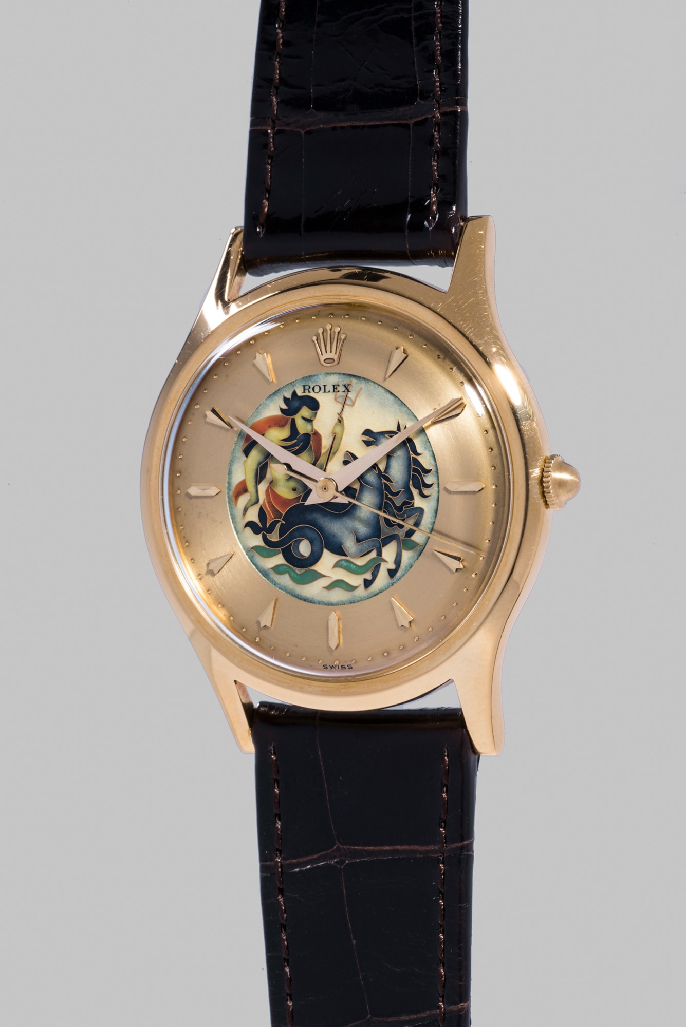 <b>ROLEX </b>Reference 8382, circa 1953. An extremely rare and attractive yellow gold wristwatch with cloisonn&#233; enamel dial depicting Neptune.