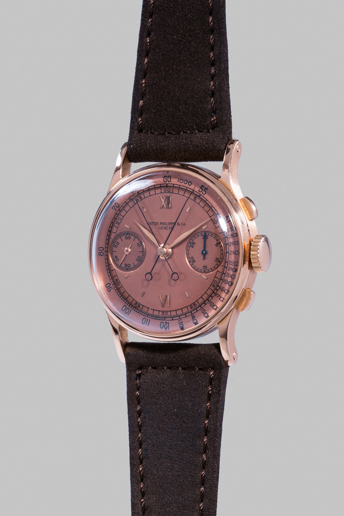 <b>PATEK PHILIPPE </b>Reference 1436, circa 1941. An extremely fine and rare pink gold split seconds chronograph wristwatch with pink dial, original certificate, envelope, invoice and presentation box.