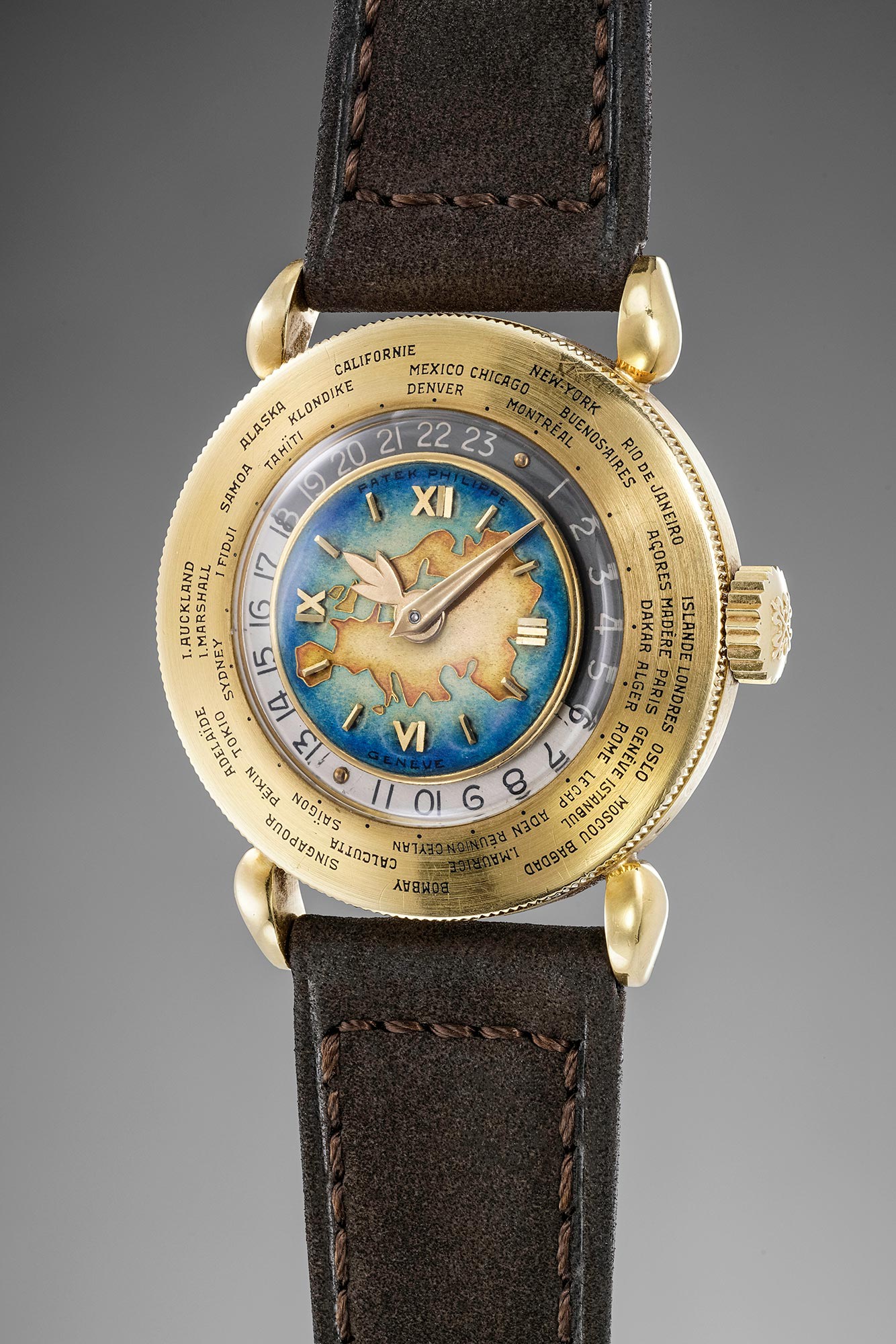 An exceptionally fine, important and attractive yellow gold Patek Philippe world time Reference 1415 with 'Eurasia' polychrome cloisonne´ enamel dial