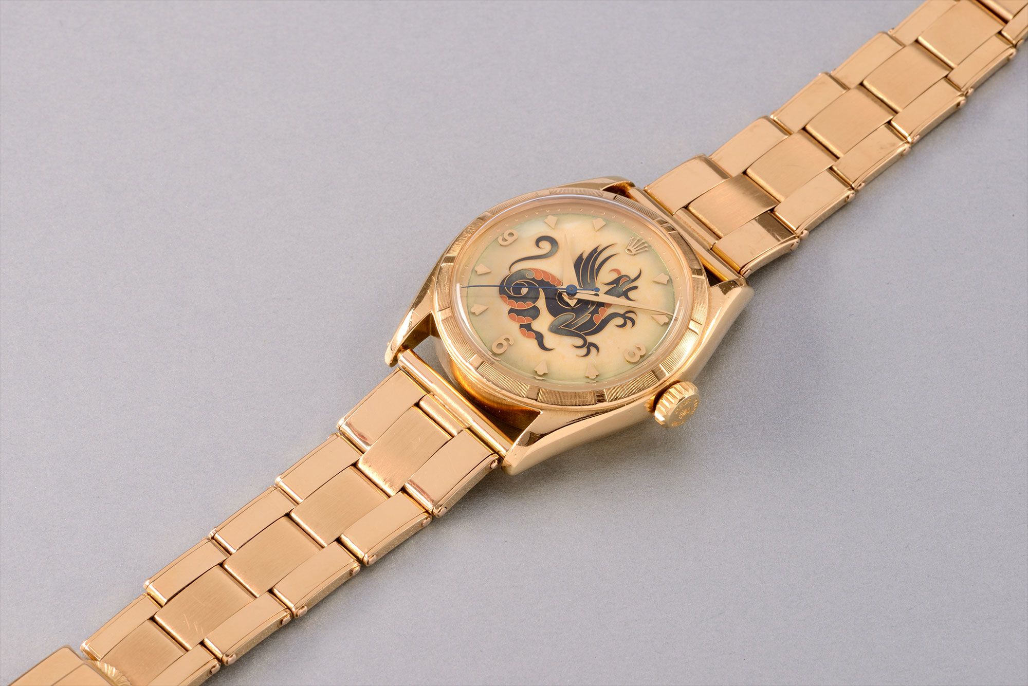 <b>ROLEX </b>An important and possibly unique yellow gold wristwatch with cloisonn&#233; enamel dial depicting a Dragon, reference 6085. Manufactured circa 1951.