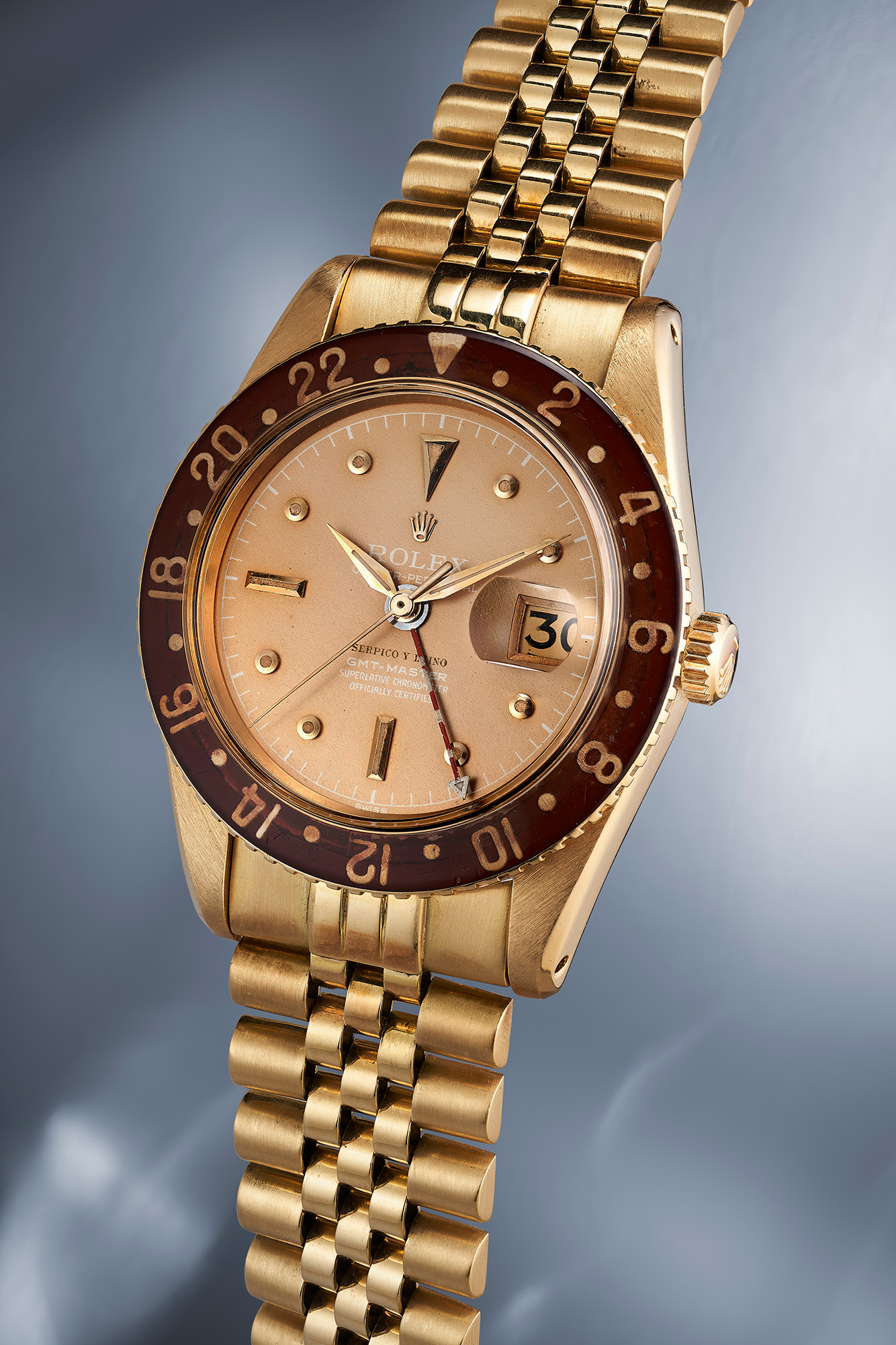 A highly exclusive, important and exceptionally well-preserved yellow gold dual time Rolex GMT-Master Reference 6542 retailed by Serpico Y Laino