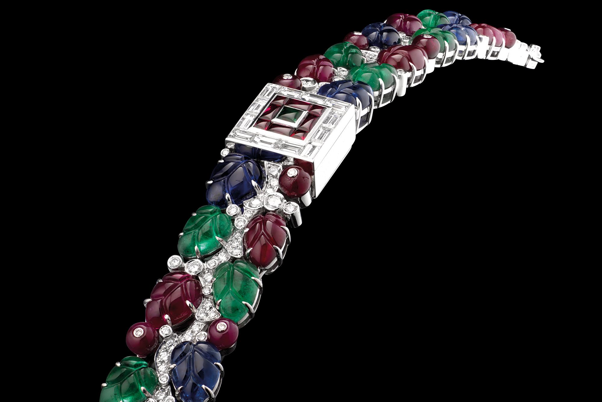 <b>CARTIER </b>A lady's unique and highly important white gold and multi gem-set tutti frutti bracelet watch with concealed mother-of-pearl dial. Manufactured in 1997. <b><br />
<br />
</b>