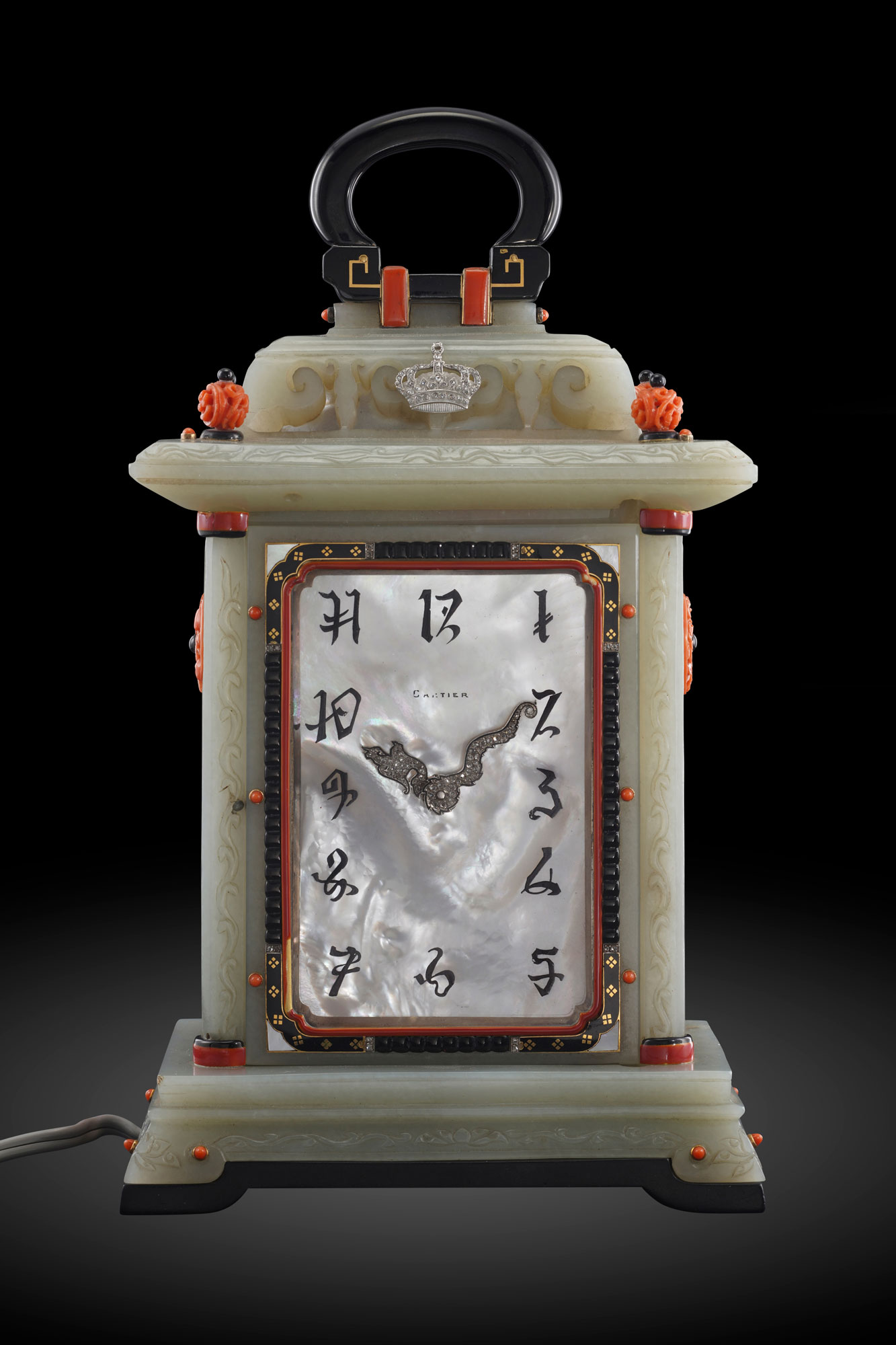 <p><strong>CARTIER</strong> <em>An exceptional, unique and museum-quality nephrite, onyx, laquer, diamond and coral-set illuminated desk clock styled as a lantern with double mother-of-pearl dials, and presentation box</em>, Circa 1925</p>
