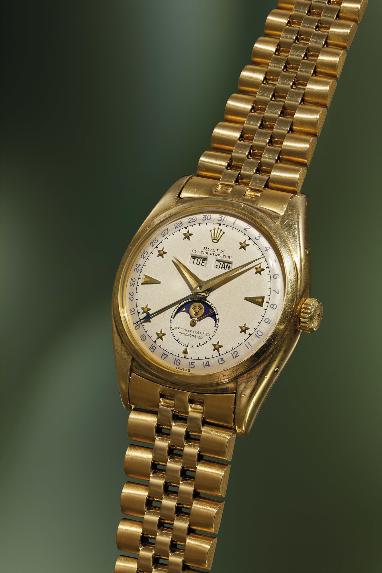 <b>ROLEX </b>An exceptionally fine, rare and important yellow gold triple calendar wristwatch with star-set numerals, moon phases and bracelet, reference 6062, circa 1952.