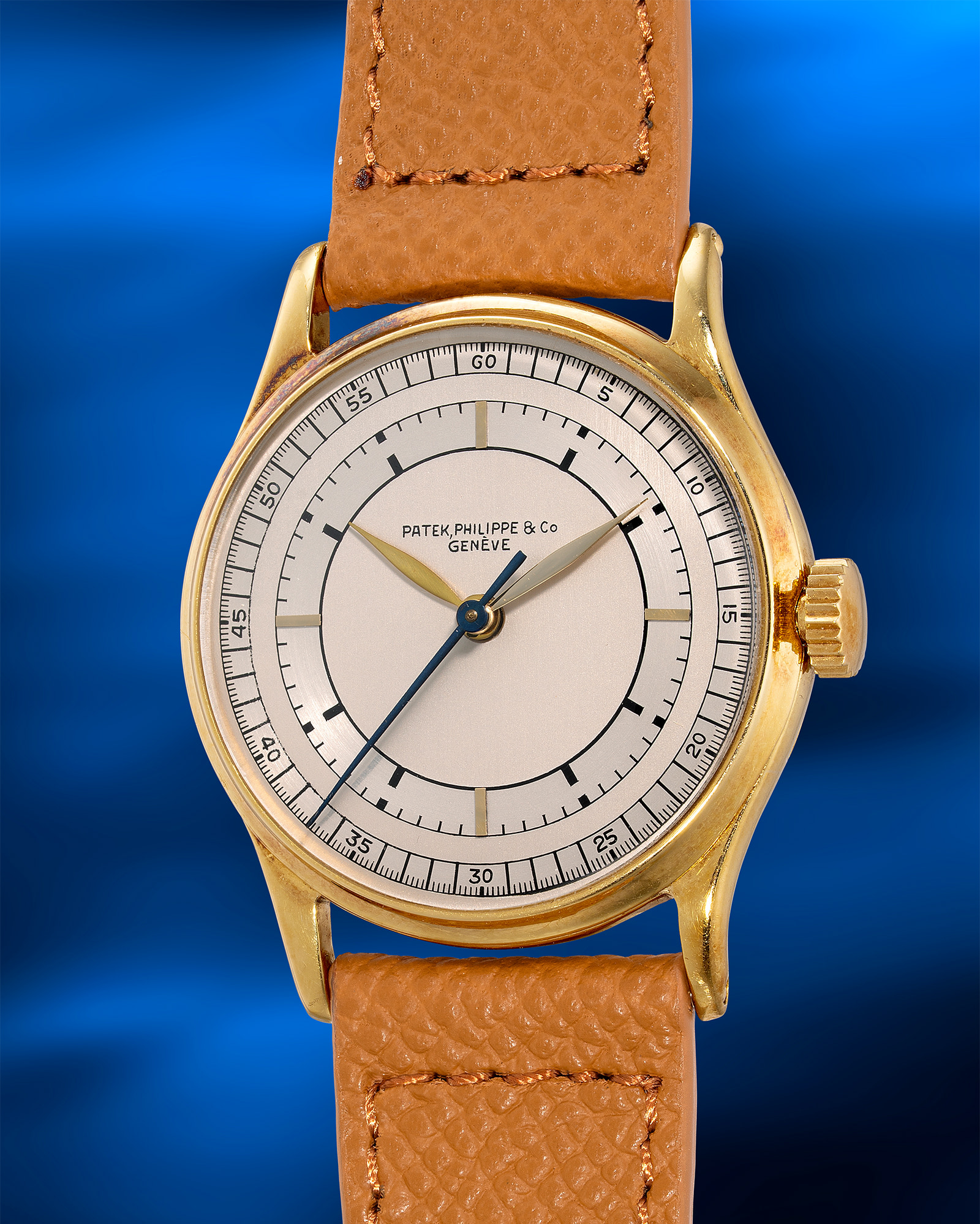 <p><strong>PATEK PHILIPPE</strong> <em>Ref. 130 in yellow gold with two-tone silvered sector dial, the only known example with center seconds</em></p>
