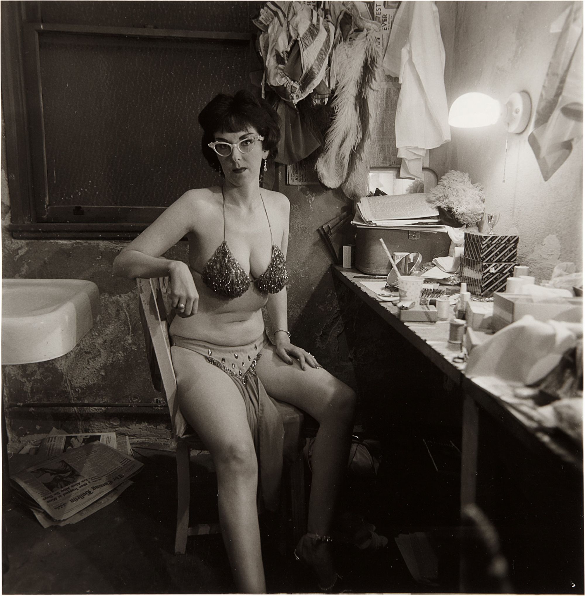 <b>DIANE ARBUS</b> <i>Stripper, Miss Sata Lyte, in her dressing room with glasses Atlantic City, N.J.</i>, 1962
