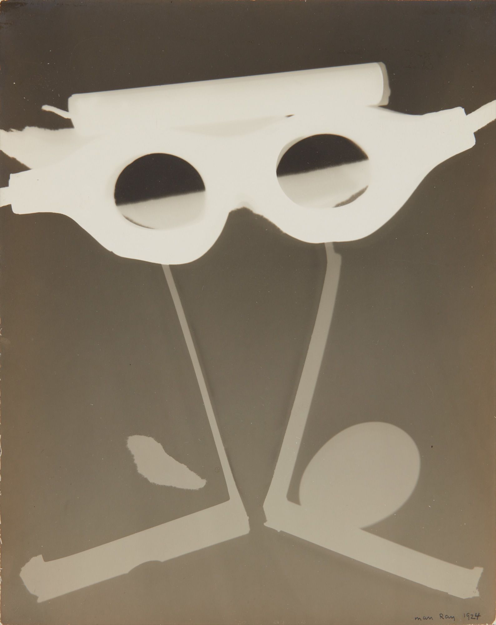 <b>MAN RAY</b> <i>Rayograph with Goggles, Egg and Candle</i>, 1924