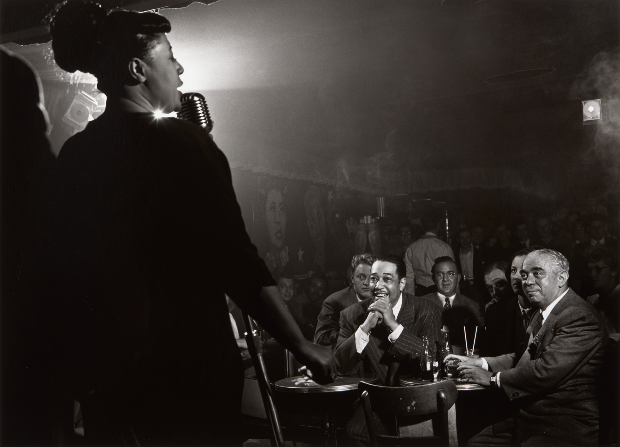 <p><strong>HERMAN LEONARD</strong> <em>Ella Fitzgerald with Duke Ellington, Benny Goodman and Richard Rogers, NYC</em>, 1948</p>