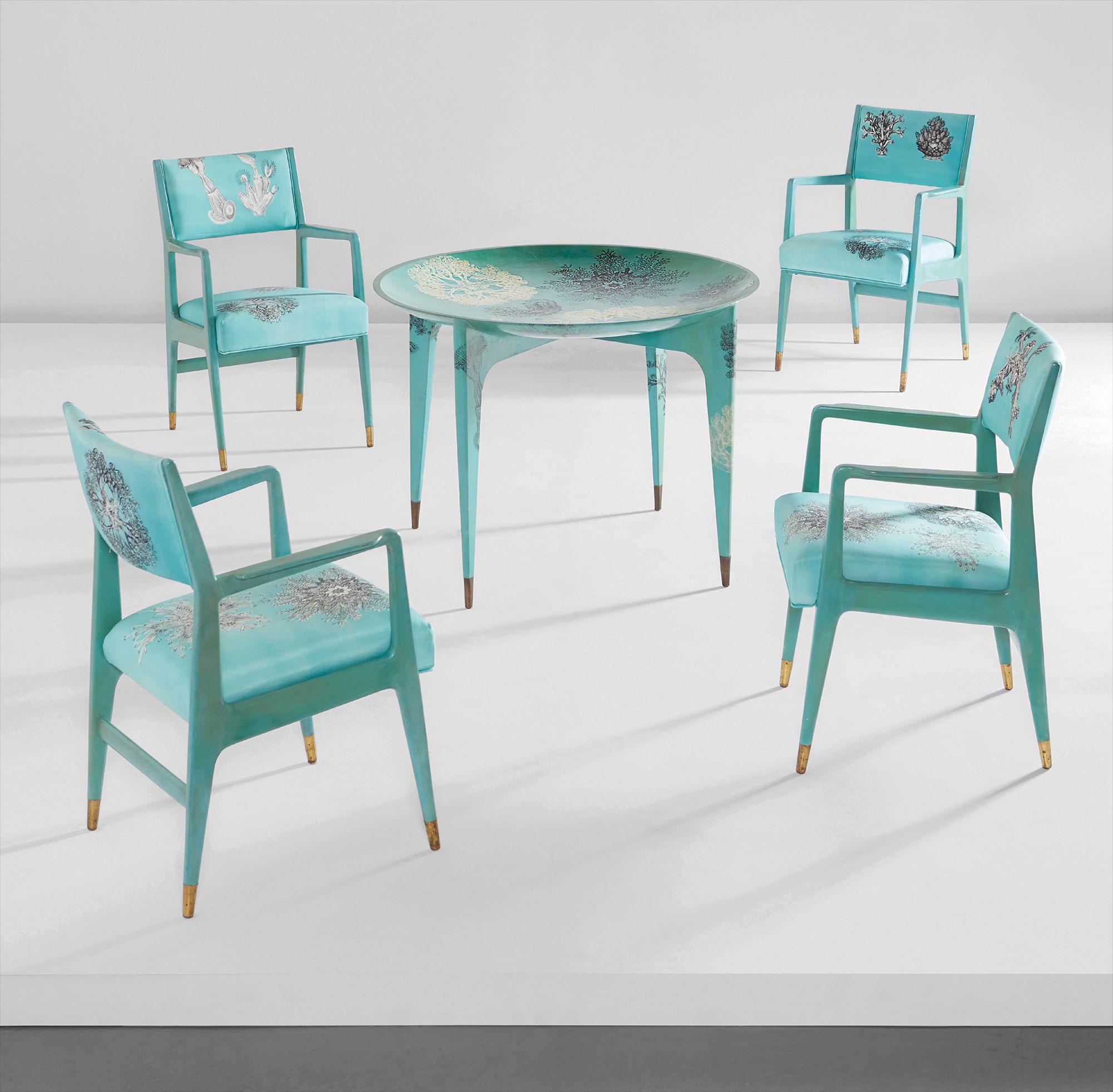 <b>GIO PONTI AND PIERO FORNASETTI</b><i> Rare 'Madrepore' dining table and set of four armchairs</i>, circa 1950