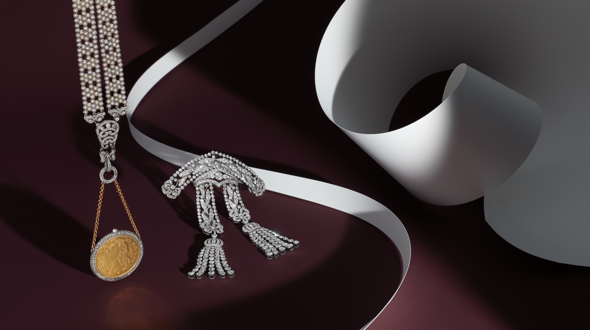 <p>A Belle &Eacute;poque Diamond Brooch, Circa 1910; <strong>CARTIER</strong>. A Diamond, Seed Pearl, and Louis d&rsquo;or Coin Sautoir Pendant Watch, Circa 1910 &nbsp;</p>
