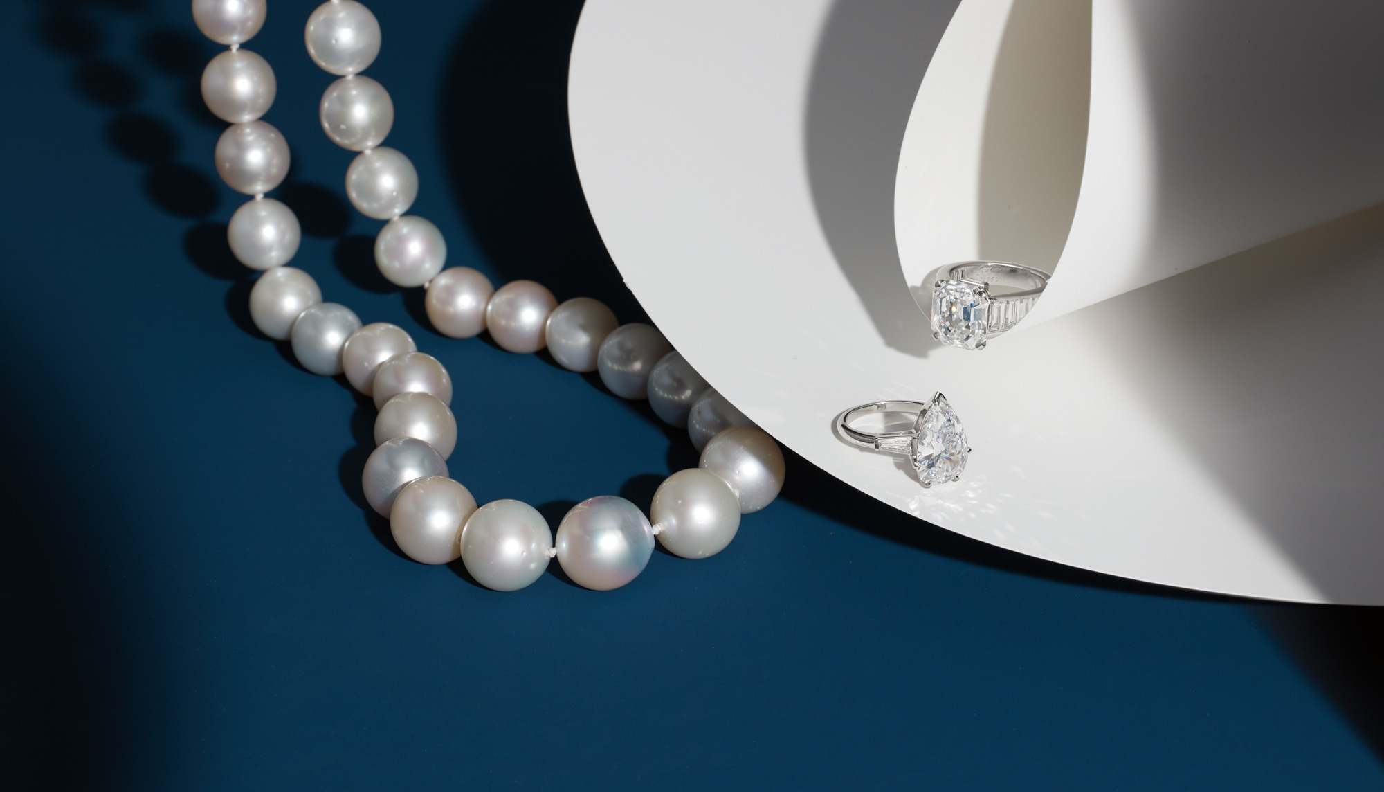<p>A South Sea Cultured Pearl Necklace; A Diamond Ring;&nbsp;<strong>CARTIER</strong>. An Important Diamond and Platinum Ring</p>
