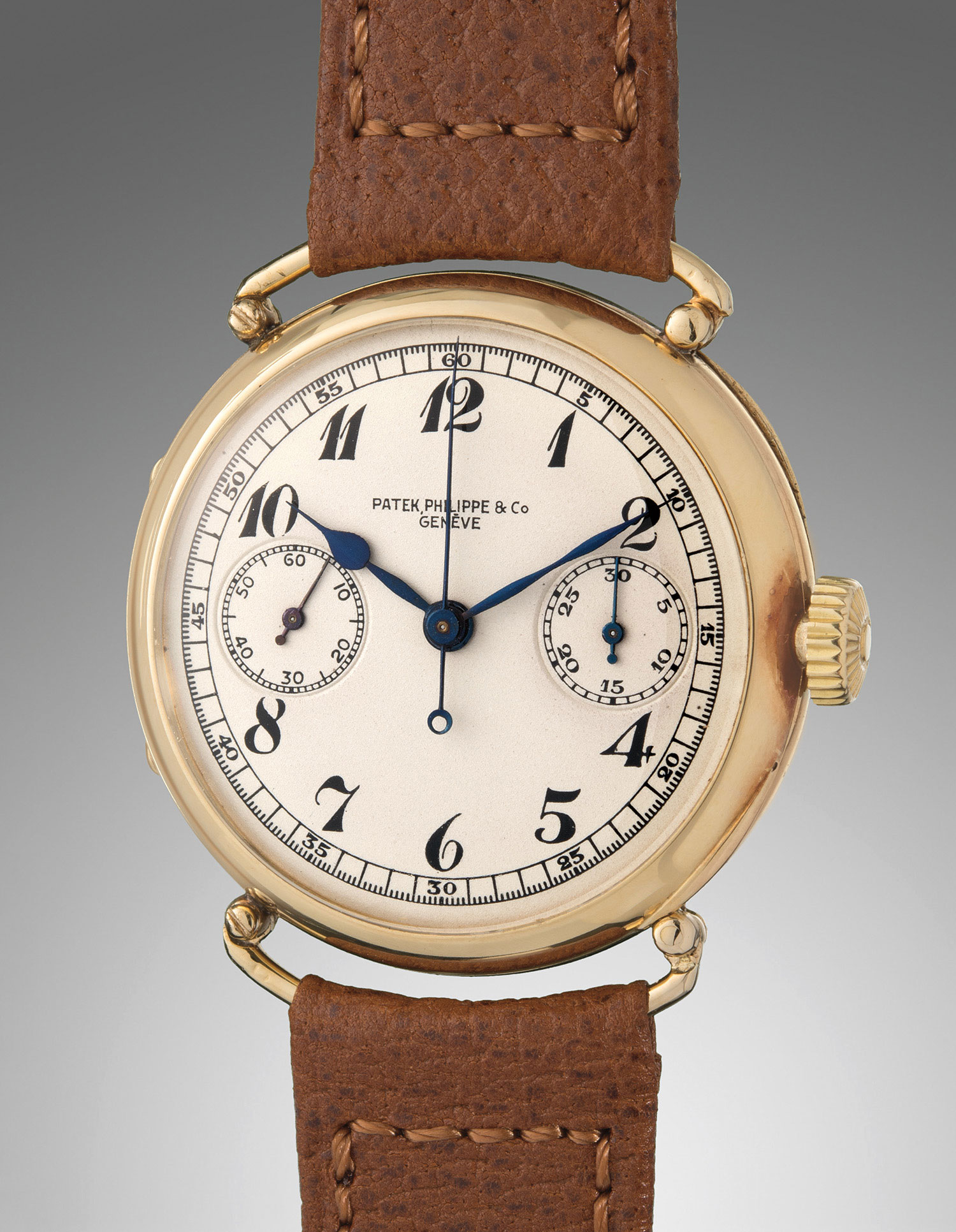 <b>PATEK PHILIPPE</b> An extremely rare yellow gold single button chronograph wristwatch with hinged officer-style wire lug case and Breguet numerals, circa 1928