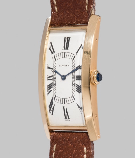 yellow gold curved wristwatch 