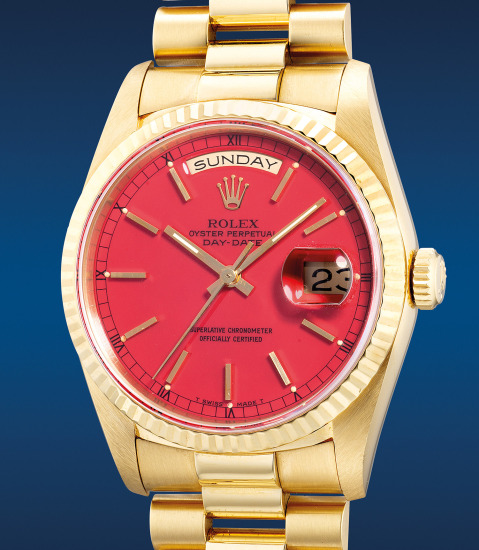 A rare, extremely well-preserved and attractive yellow gold wristwatch with center seconds, day, date, red “Stella” dial, bracelet, guarantee and presentation box